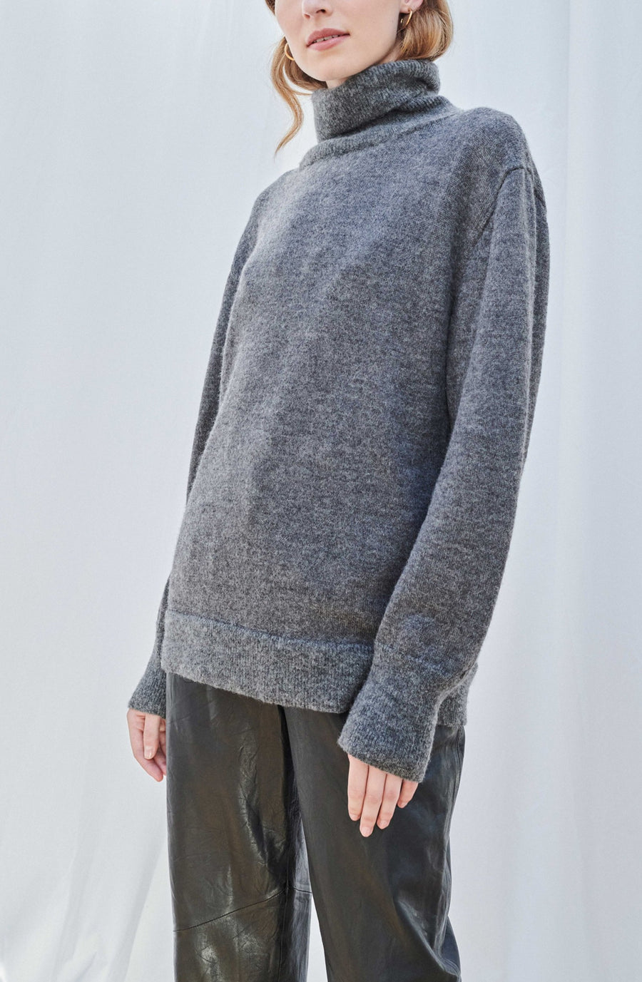 model wearing AQVAROSSA Juliaca wide knitted turtleneck in colour dark grey extra fine alpaca front view